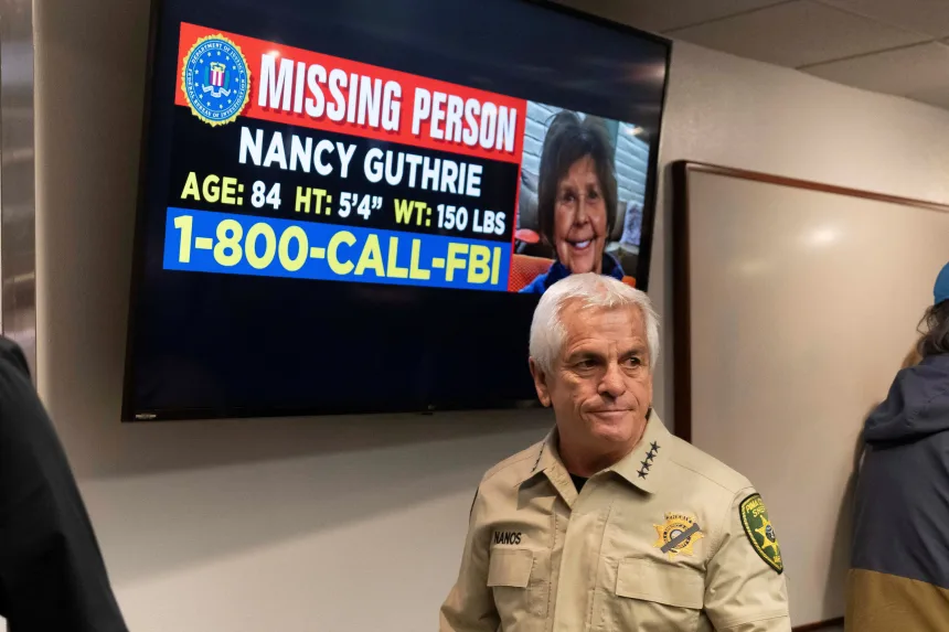 After providing an update on the inquiry following Nancy Guthrie's disappearance in February 2026, Pima County Sheriff Chris Nanos leaves the press room past a missing people poster. Reuters/Rebecca Noble